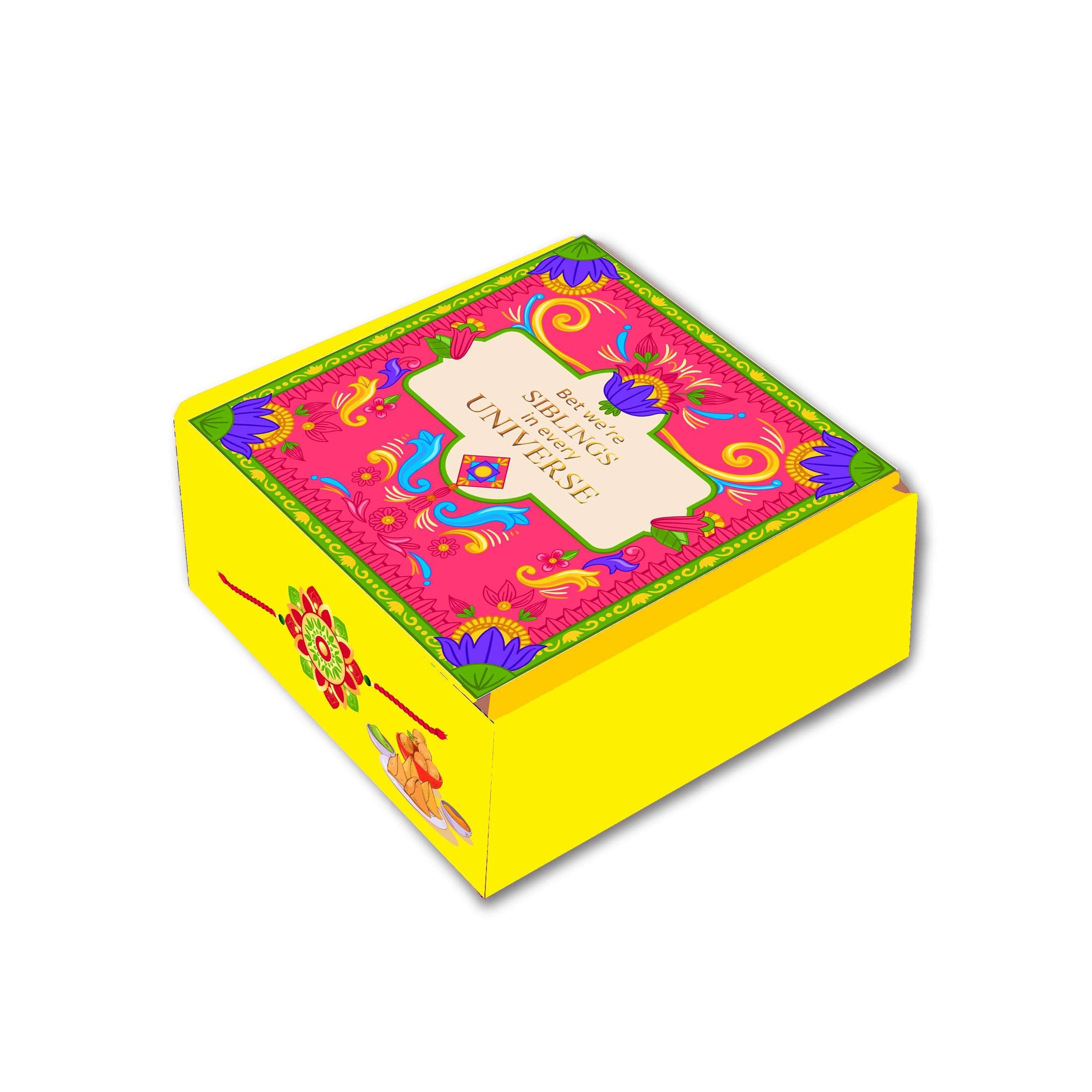 A colorful corrugated cardboard gift box with floral and geometric patterns and a 'Happy Raksha Bandhan' greeting card attached on top.
